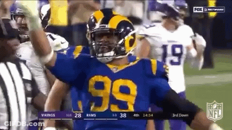 99 Football Player Celebrating Touchdown In Blue And Yellow Uniform GIF