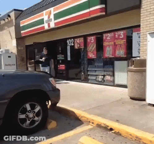 A 7 Eleven Store Front With A Car Parked In Front Of It GIF