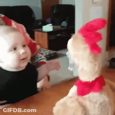 A Baby And A Stuffed Animal Are Looking At Each Other . GIF