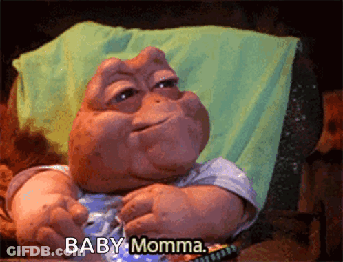 A Baby Dinosaur Says Baby Momma While Sitting In A Chair GIF