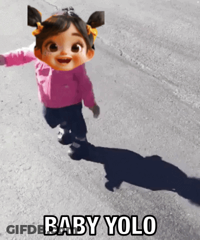 A Baby Doll Is Running Down A Street With The Words Baby Yolo Behind Her GIF