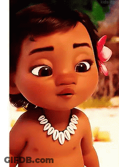 A Baby Doll Wearing A Necklace With Shells And A Flower In Her Hair . GIF