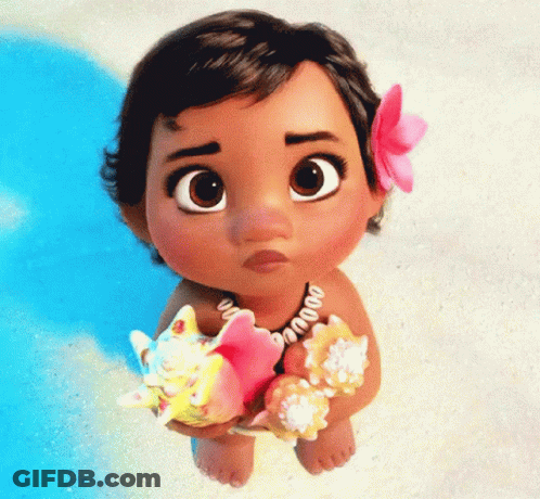 A Baby Doll With A Flower In Her Hair Holds Seashells GIF