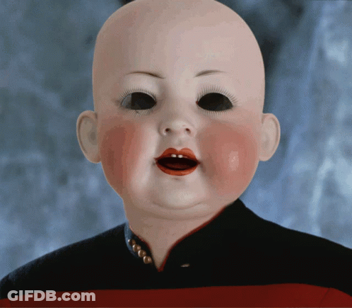 A Baby Doll With Red Lips And Black Eyes Is Wearing A Black And Red Striped Shirt GIF