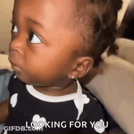 A Baby Girl Is Looking At The Camera With The Words `` Looking For You '' Written On The Bottom . GIF