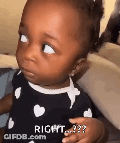 A Baby Girl Is Making A Funny Face And Looking At The Camera While Wearing A Black And White Dress . GIF