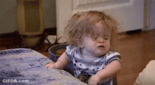 Baby Girl Sitting On Couch With Eyes Closed GIF