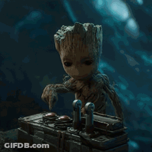 Baby Groot Sitting At Table With Remote GIF