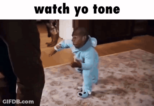 A Baby In A Blue Onesie Is Walking On A Rug With The Words " Watch Yo Tone " Above Him GIF