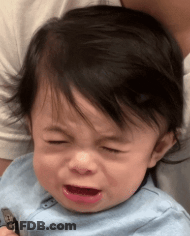 A Baby In A Blue Shirt Is Crying GIF