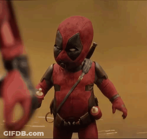 A Baby In A Deadpool Costume Is Holding A Bottle GIF