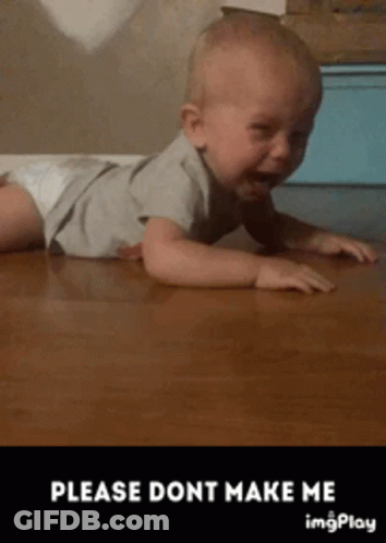A Baby In A Diaper Is Crawling On A Wooden Floor . GIF