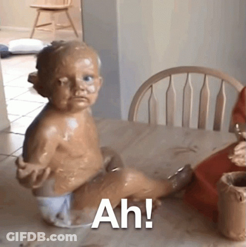 A Baby In A Diaper Is Sitting At A Table With The Words Ah Written On The Bottom GIF