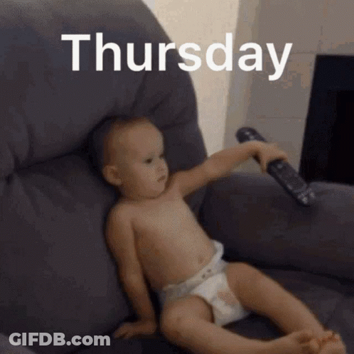 A Baby In A Diaper Is Sitting In A Chair Holding A Remote Control With The Date Thursday Written Above It GIF