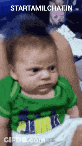 A Baby In A Green Shirt Is Being Held In Someone 'S Arms With The Words Starttamilchat.in Above It GIF
