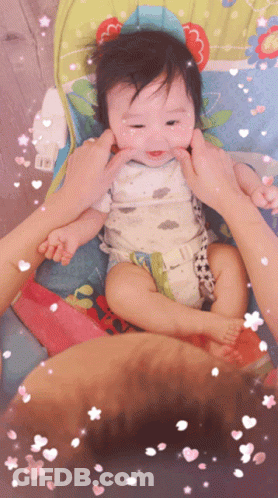 A Baby In A High Chair Being Held By A Person GIF