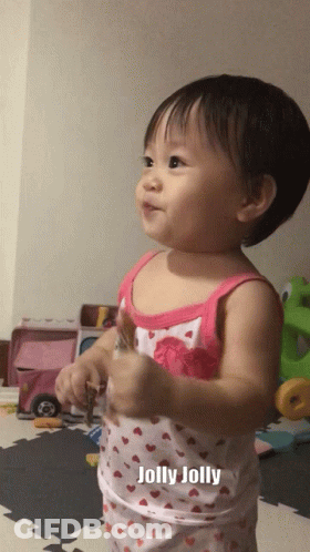 A Baby In A Pink And White Tank Top With The Word Jolly On It GIF