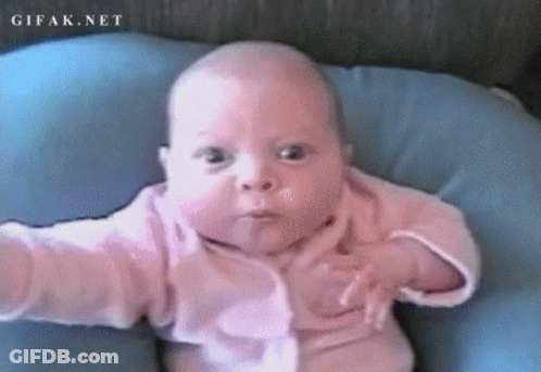 A Baby In A Pink Shirt Is Laying On A Blue Pillow With Gifak.net Written On The Bottom Right GIF