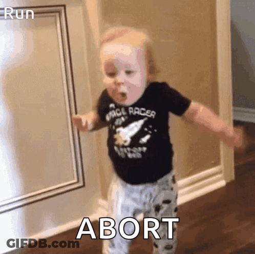 A Baby In A Space Racer Shirt Is Dancing In A Hallway With The Word Abort In The Corner . GIF