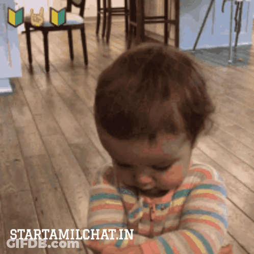 A Baby In A Striped Shirt Is Looking Down With The Words Starttamilchat.in Below It GIF