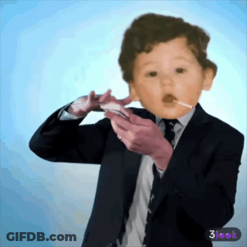 A Baby In A Suit And Tie Is Holding A Cell Phone GIF