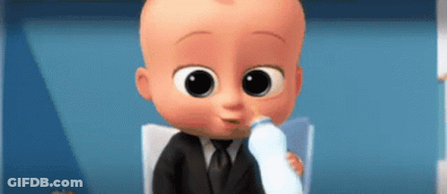 A Baby In A Suit Is Drinking Milk From A Bottle . GIF