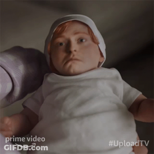 A Baby In A White Shirt Is Being Held By A Person With The Words Prime Video Behind It GIF