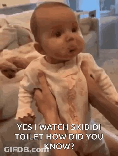 A Baby Is Being Held In A Person 'S Arms And Making A Funny Face . GIF
