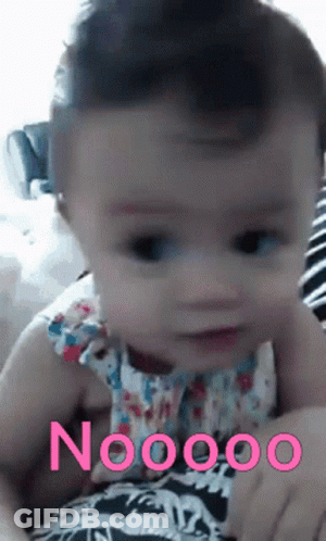 A Baby Is Being Held In Someone 'S Arms With The Word Noooo On The Bottom Right GIF