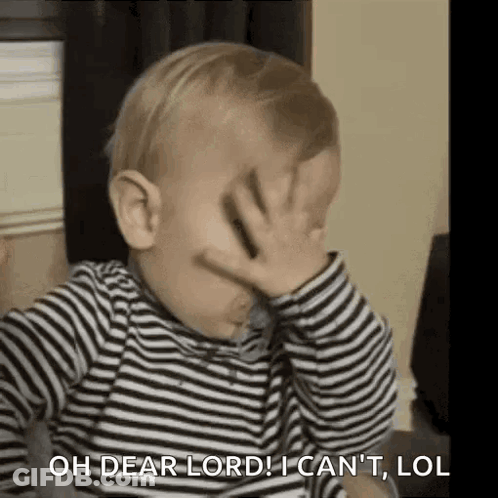 A Baby Is Covering His Face With His Hand . GIF