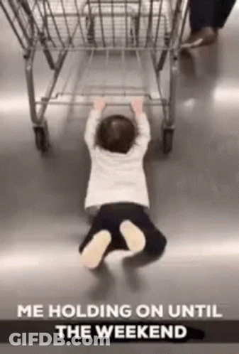 A Baby Is Crawling On The Floor Next To A Shopping Cart With The Caption `` Me Holding On Until The Weekend '' . GIF