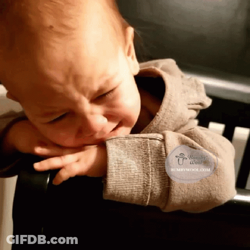 A Baby Is Crying And Has A Humbywool.com Logo On His Arm GIF