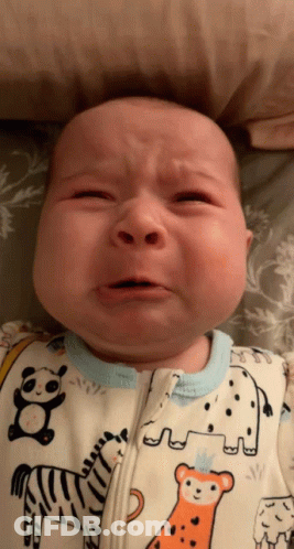 A Baby Is Crying And Wearing A Zebra And Elephant Onesie GIF