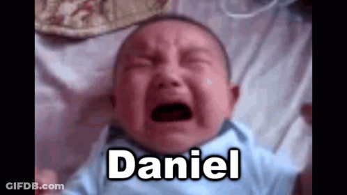 A Baby Is Crying On A Bed With The Name Daniel . GIF