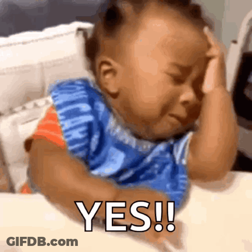 A Baby Is Crying While Holding His Head And The Word Yes Is On The Screen GIF