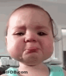 A Baby Is Crying With A Tear Coming Out Of Her Nose . GIF