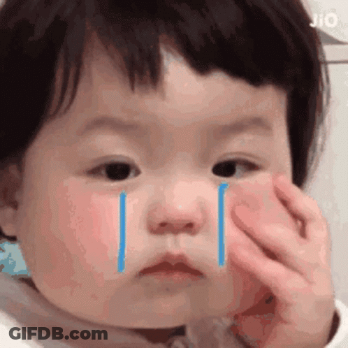 A Baby Is Crying With Tears Coming Out Of Her Eyes . GIF
