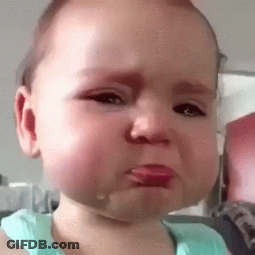 A Baby Is Crying With Tears Coming Out Of His Mouth . GIF