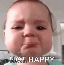 A Baby Is Crying With The Words `` Not Happy '' Written On Its Face . GIF