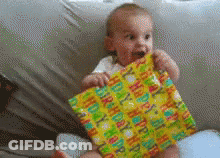A Baby Is Holding A Happy Birthday Wrapped Present GIF