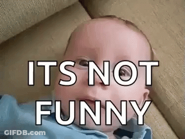A Baby Is Laying On A Couch With The Words `` It 'S Not Funny '' Written On It 'S Face . GIF