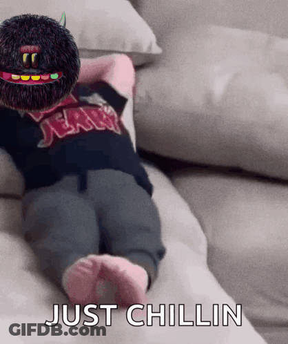 A Baby Is Laying On A Couch With The Words Just Chillin Written On The Bottom GIF