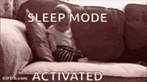 A Baby Is Laying On A Couch With The Words `` Sleep Mode Activated '' Written Above It . GIF