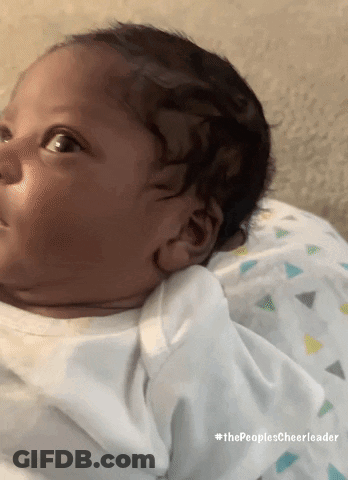 A Baby Is Laying On A Pillow With #Thepeoplescheerleader Written Below It GIF