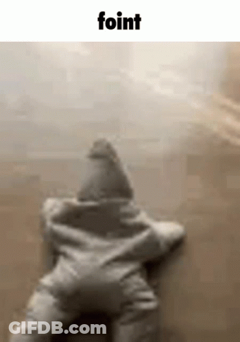 A Baby Is Laying On The Floor In A Star Shaped Outfit . GIF