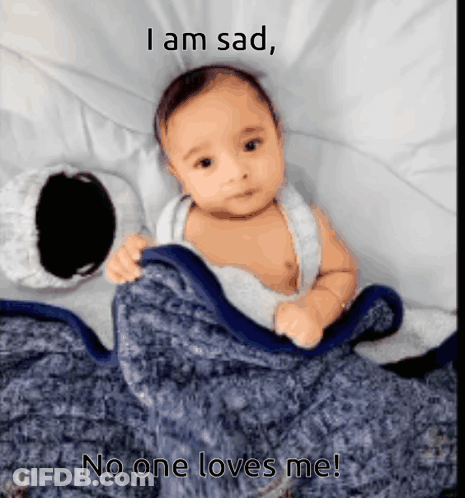 A Baby Is Laying Under A Blanket With The Caption I Am Sad GIF