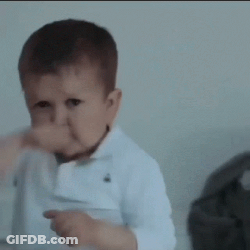 A Baby Is Making A Funny Face And Giving A Thumbs Up Sign . GIF