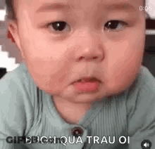 A Baby Is Making A Funny Face And Making A Funny Face With His Mouth Open . GIF