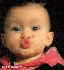 A Baby Is Making A Funny Face With A Red Lip . GIF