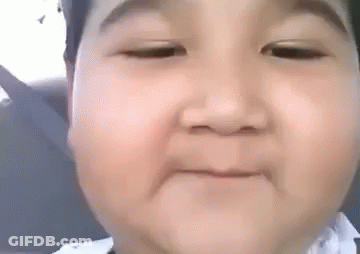 A Baby Is Making A Funny Face With His Eyes Closed And His Mouth Open . GIF